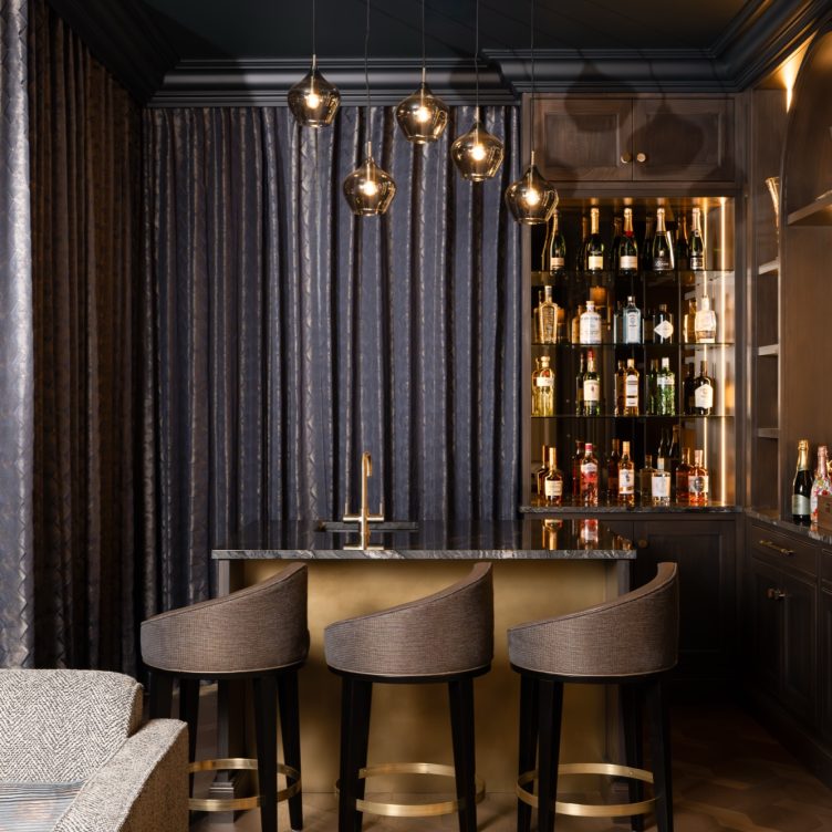 Antique brass cladding in a home whisky bar
