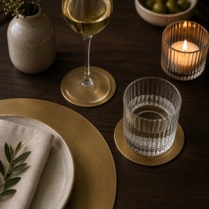 Brass placemats and coasters on a dining table