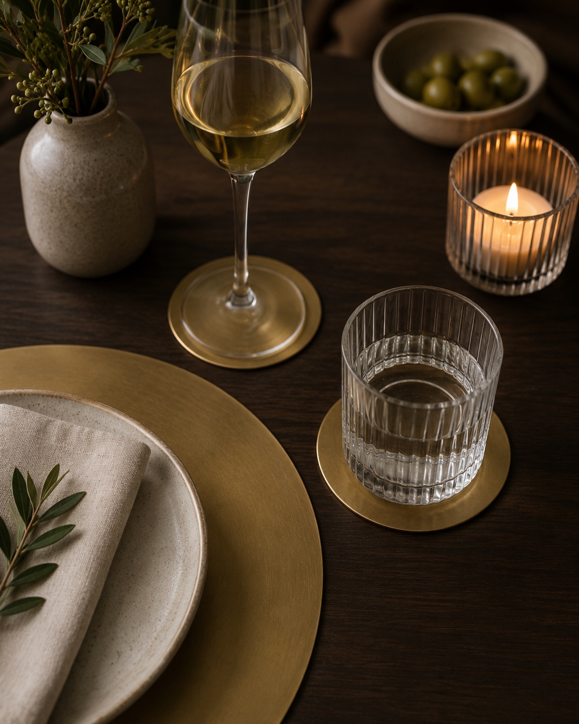 Brass placemats and coasters on a dining table