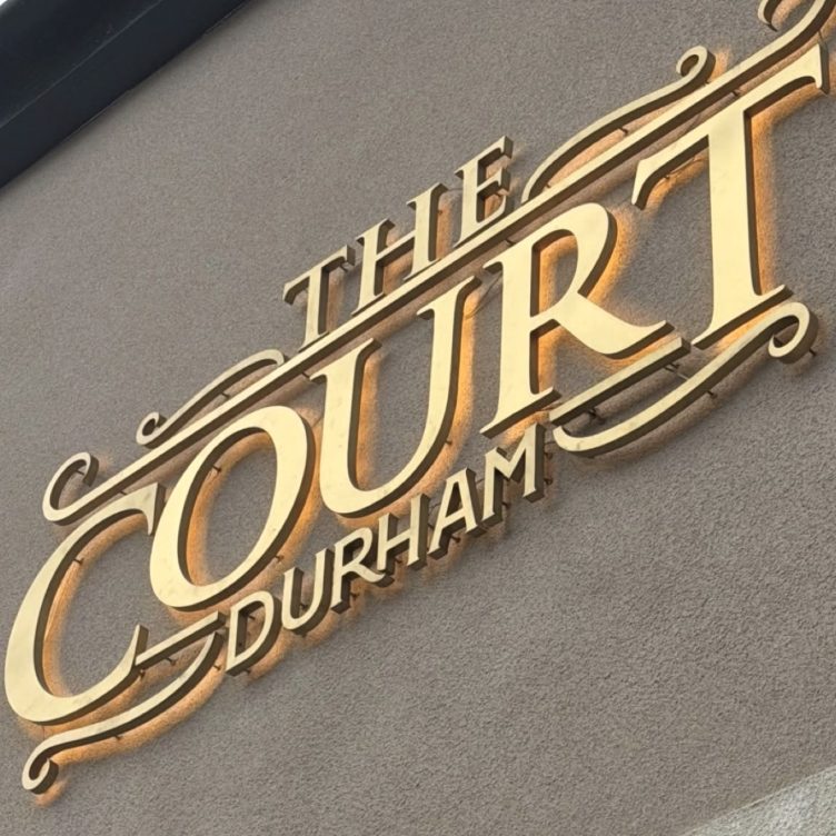 The Court Durham gold metal lettering close-up